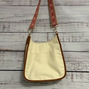 ah-dorned shoulder or crossbody natural canvas bag